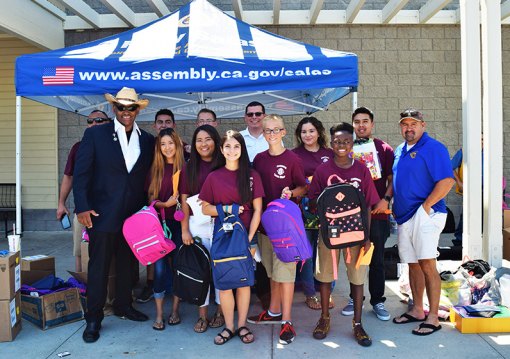 Assembly Member Rudy Salas, Lemoore Councilmembers Eddie Neal and Ray Madrigal, and members of the Kings Lions Club helped "Stuff the Bus" Saturday.